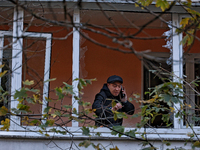 A man stands on the balcony of a residential building damaged by the Russian drone attack in the Khadzhybeiskyi district of Odesa, southern...