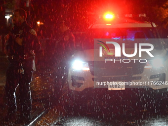 NYPD police officers guard the crime scene as heavy rainfall ends the rainless drought streak. A 16-year-old boy is shot in the East Flatbus...