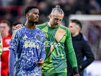 AFC Ajax Amsterdam defender Jorrel Hato and AFC Ajax Amsterdam goalkeeper Remko Pasveer participate in the match between Twente and Ajax at...