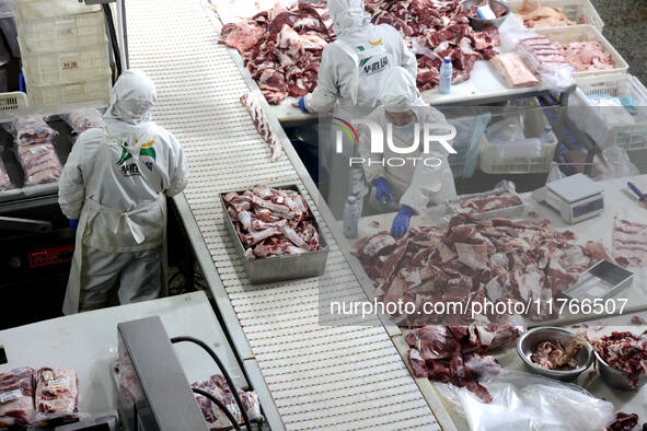 Workers divide beef at a workshop of a beef processing enterprise in Binzhou, China, on November 11, 2024. Global food prices rise in Octobe...