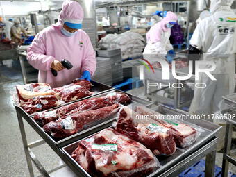 Workers divide beef at a workshop of a beef processing enterprise in Binzhou, China, on November 11, 2024. Global food prices rise in Octobe...