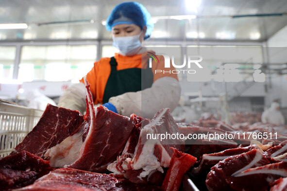 Workers divide beef at a workshop of a beef processing enterprise in Binzhou, China, on November 11, 2024. Global food prices rise in Octobe...