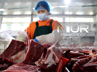 Workers divide beef at a workshop of a beef processing enterprise in Binzhou, China, on November 11, 2024. Global food prices rise in Octobe...