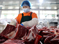 Workers divide beef at a workshop of a beef processing enterprise in Binzhou, China, on November 11, 2024. Global food prices rise in Octobe...