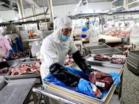 Workers divide beef at a workshop of a beef processing enterprise in Binzhou, China, on November 11, 2024. Global food prices rise in Octobe...