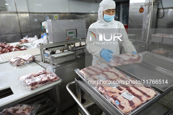 Workers divide beef at a workshop of a beef processing enterprise in Binzhou, China, on November 11, 2024. Global food prices rise in Octobe...