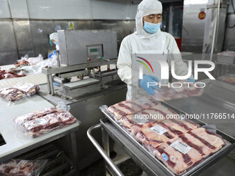 Workers divide beef at a workshop of a beef processing enterprise in Binzhou, China, on November 11, 2024. Global food prices rise in Octobe...