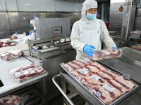 Workers divide beef at a workshop of a beef processing enterprise in Binzhou, China, on November 11, 2024. Global food prices rise in Octobe...