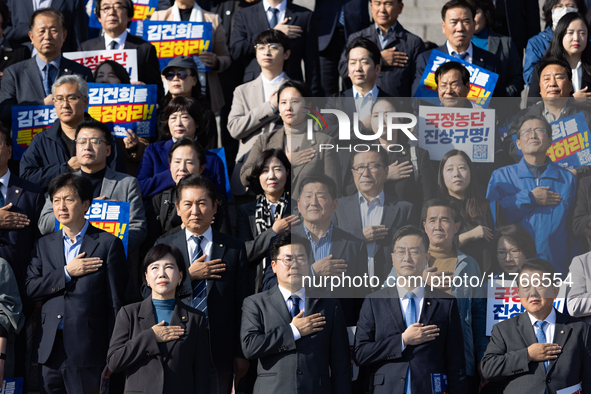 Democratic Party Floor Leader Park Chan-dae (center) and other Democratic Party lawmakers chant slogans during the launch ceremony of the 10...