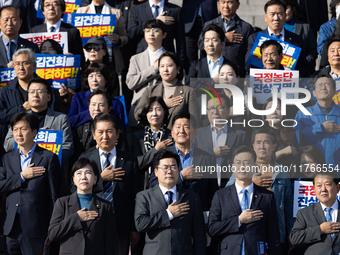 Democratic Party Floor Leader Park Chan-dae (center) and other Democratic Party lawmakers chant slogans during the launch ceremony of the 10...