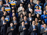 Democratic Party Floor Leader Park Chan-dae (center) and other Democratic Party lawmakers chant slogans during the launch ceremony of the 10...