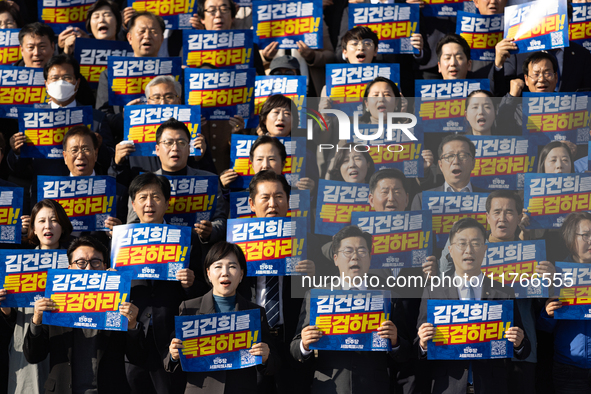 Democratic Party Floor Leader Park Chan-dae (center) and other Democratic Party lawmakers chant slogans during the launch ceremony of the 10...