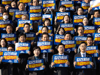 Democratic Party Floor Leader Park Chan-dae (center) and other Democratic Party lawmakers chant slogans during the launch ceremony of the 10...