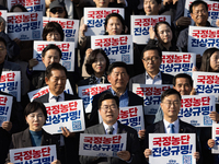 Democratic Party Floor Leader Park Chan-dae (center) and other Democratic Party lawmakers chant slogans during the launch ceremony of the 10...