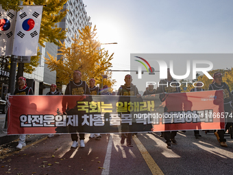 Members of the Cargo Truckers Solidarity Division of the Korean Public Service and Transport Workers' Union under the KCTU march near the Na...