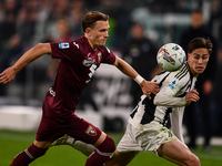 Marcus Pedersen of Torino battles for the ball with Kenan Yildiz of Juventus during the Serie A match between Juventus and Torino FC at Alli...