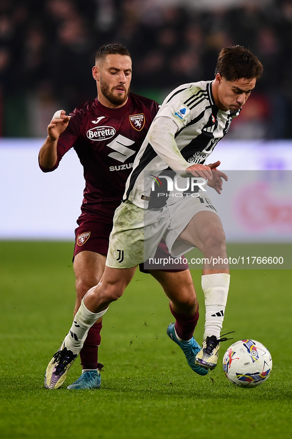 Kenan Yildiz of Juventus battles for the ball with Nikola Vlasic of Torino during the Serie A match between Juventus and Torino FC at Allian...