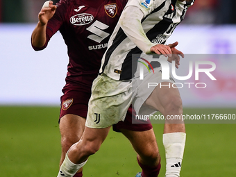 Kenan Yildiz of Juventus battles for the ball with Nikola Vlasic of Torino during the Serie A match between Juventus and Torino FC at Allian...