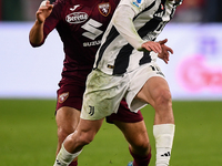 Kenan Yildiz of Juventus battles for the ball with Nikola Vlasic of Torino during the Serie A match between Juventus and Torino FC at Allian...