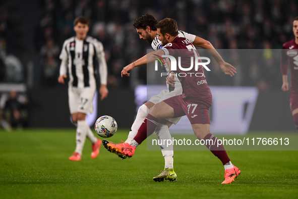 Manuel Locatelli of Juventus battles for the ball with Karol Linetty of Torino during the Serie A match between Juventus and Torino FC at Al...