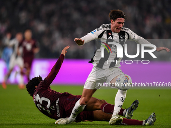 Saul Coco of Torino battles for the ball with Dusan Vlahovic of Juventus during the Serie A match between Juventus and Torino FC at Allianz...