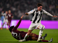 Saul Coco of Torino battles for the ball with Dusan Vlahovic of Juventus during the Serie A match between Juventus and Torino FC at Allianz...