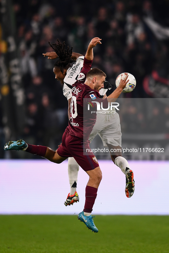 Khephren Thuram of Juventus battles for the ball with Nikola Vlasic of Torino during the Serie A match between Juventus and Torino FC at All...