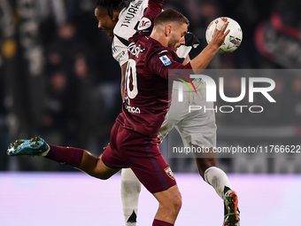 Khephren Thuram of Juventus battles for the ball with Nikola Vlasic of Torino during the Serie A match between Juventus and Torino FC at All...