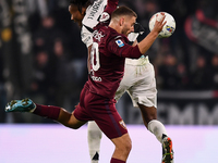 Khephren Thuram of Juventus battles for the ball with Nikola Vlasic of Torino during the Serie A match between Juventus and Torino FC at All...