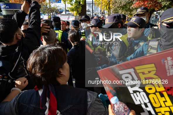 Police block protesters from advancing near the National Assembly in Yeouido, Seoul, South Korea, on November 11, 2024, leading to a brief c...