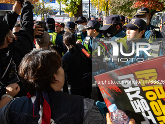 Police block protesters from advancing near the National Assembly in Yeouido, Seoul, South Korea, on November 11, 2024, leading to a brief c...