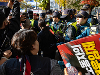 Police block protesters from advancing near the National Assembly in Yeouido, Seoul, South Korea, on November 11, 2024, leading to a brief c...