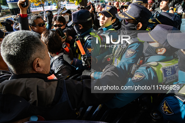 Police block protesters from advancing near the National Assembly in Yeouido, Seoul, South Korea, on November 11, 2024, leading to a brief c...