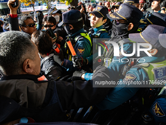 Police block protesters from advancing near the National Assembly in Yeouido, Seoul, South Korea, on November 11, 2024, leading to a brief c...