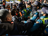 Police block protesters from advancing near the National Assembly in Yeouido, Seoul, South Korea, on November 11, 2024, leading to a brief c...