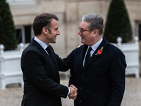 French President Emmanuel Macron receives British Prime Minister Keri Starmer at the Elysee Palace during celebrations marking the 106th ann...