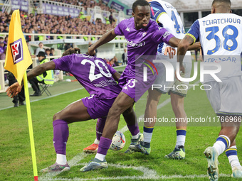 Moise Kean and Michael Kayode of ACF Fiorentina and Diego Coppola and Jackson Tchatchouaof Hellas Verona FC ,battle for the ball during the...