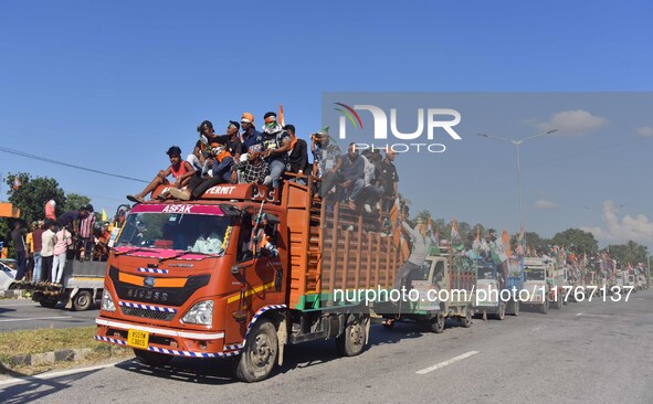 Supporters of Congress candidate Tanzil Hussain from the Samaguri constituency participate in a roadshow during an election campaign rally a...