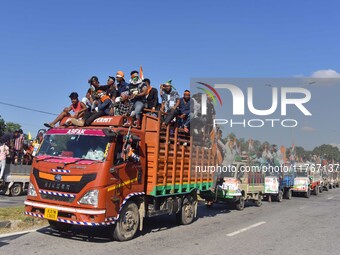 Supporters of Congress candidate Tanzil Hussain from the Samaguri constituency participate in a roadshow during an election campaign rally a...