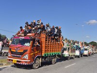 Supporters of Congress candidate Tanzil Hussain from the Samaguri constituency participate in a roadshow during an election campaign rally a...