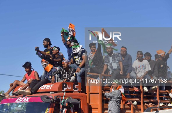 Supporters of Congress candidate Tanzil Hussain from the Samaguri constituency participate in a roadshow during an election campaign rally a...