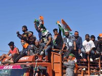 Supporters of Congress candidate Tanzil Hussain from the Samaguri constituency participate in a roadshow during an election campaign rally a...