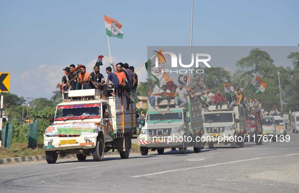 Supporters of Congress candidate Tanzil Hussain from the Samaguri constituency participate in a roadshow during an election campaign rally a...