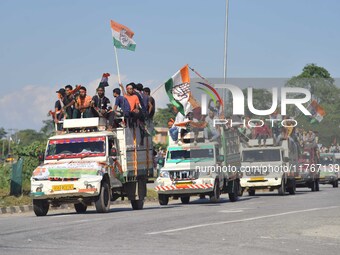 Supporters of Congress candidate Tanzil Hussain from the Samaguri constituency participate in a roadshow during an election campaign rally a...