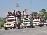 Supporters of Congress candidate Tanzil Hussain from the Samaguri constituency participate in a roadshow during an election campaign rally a...