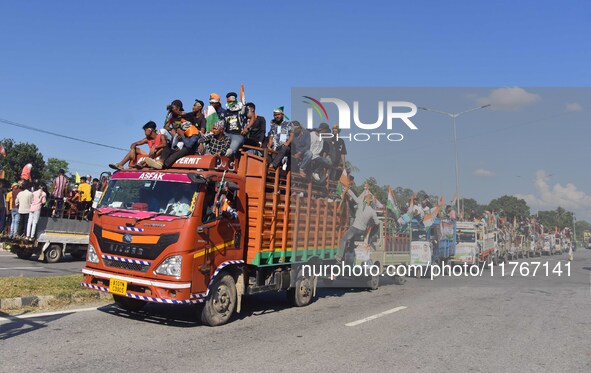 Supporters of Congress candidate Tanzil Hussain from the Samaguri constituency participate in a roadshow during an election campaign rally a...