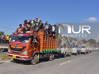 Supporters of Congress candidate Tanzil Hussain from the Samaguri constituency participate in a roadshow during an election campaign rally a...