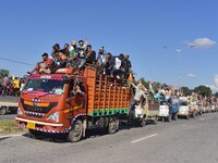 Supporters of Congress candidate Tanzil Hussain from the Samaguri constituency participate in a roadshow during an election campaign rally a...