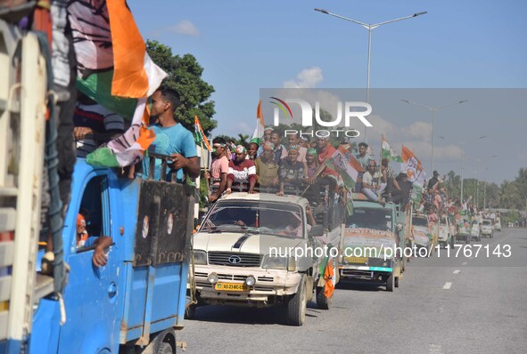 Supporters of Congress candidate Tanzil Hussain from the Samaguri constituency participate in a roadshow during an election campaign rally a...