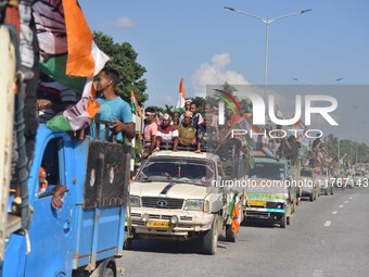 Supporters of Congress candidate Tanzil Hussain from the Samaguri constituency participate in a roadshow during an election campaign rally a...